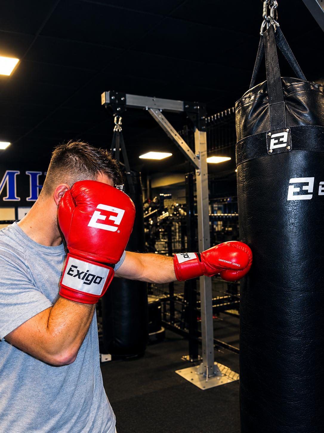 FAB Boxing member training on a heavy bag in red gloves