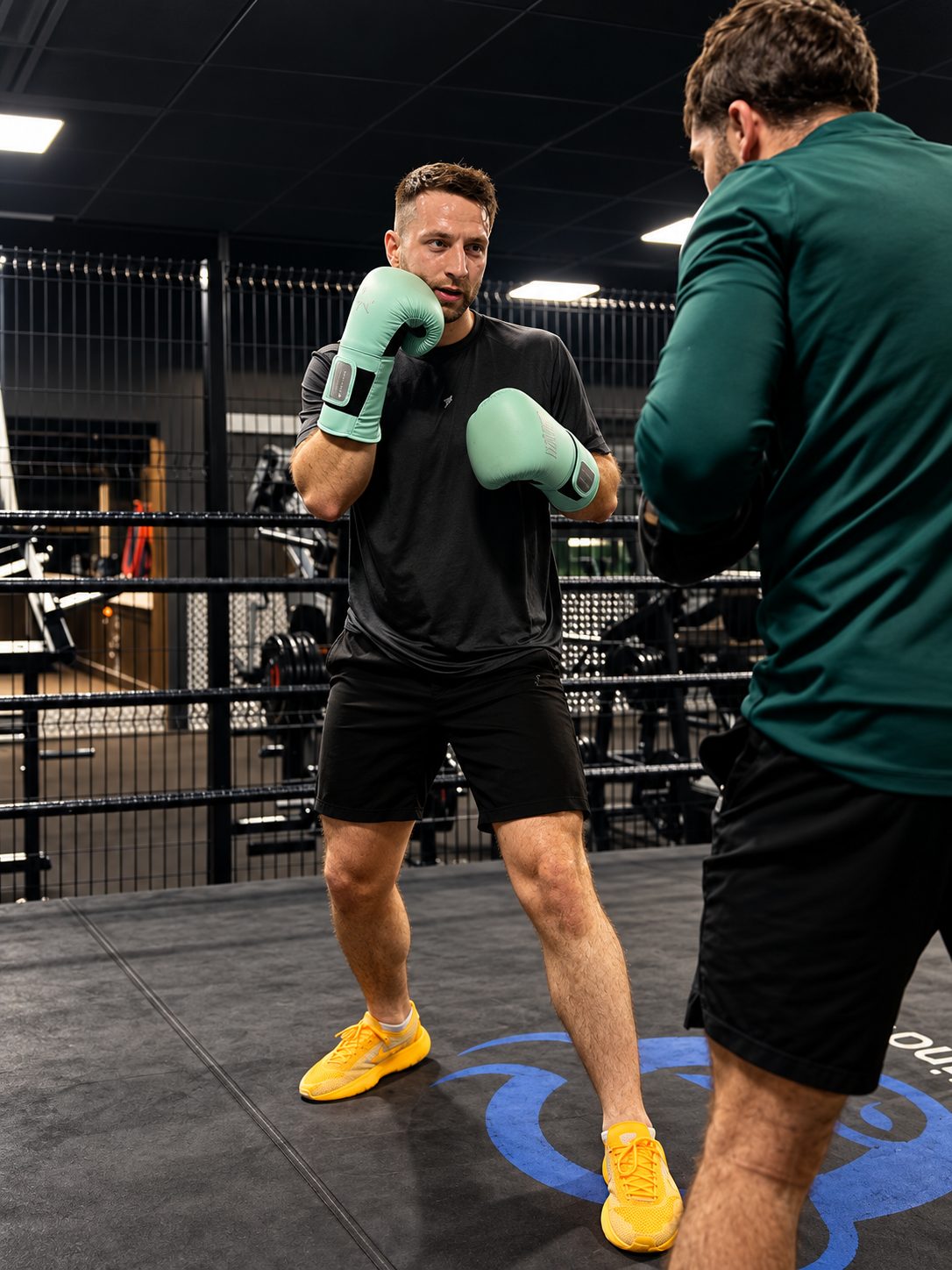 Coach giving boxing instruction in the ring